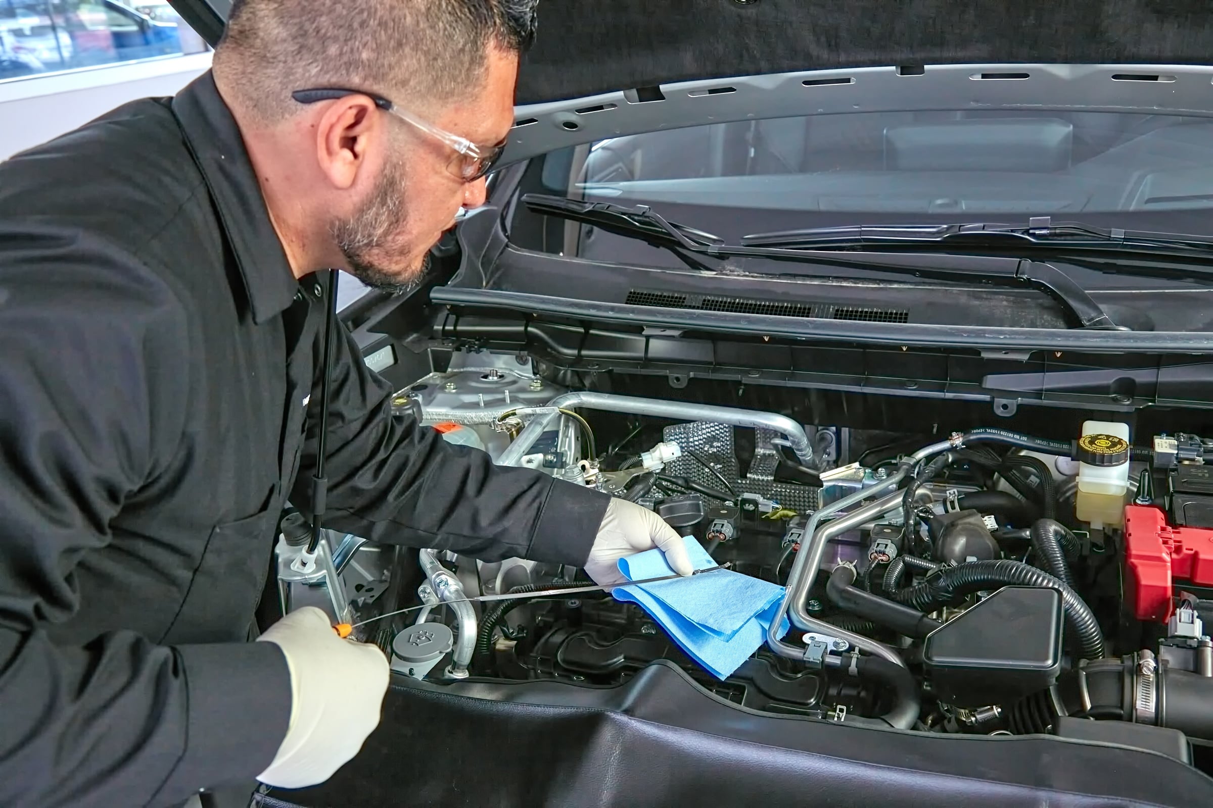 Service technician working in a vehicle engine bay