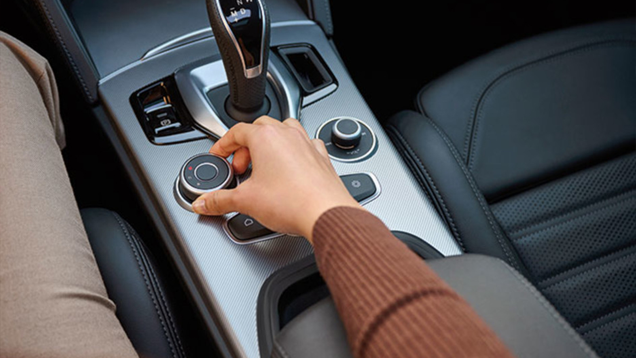 View of an owner of a 2026 Alfa Romeo Stelvio changing the driving mode