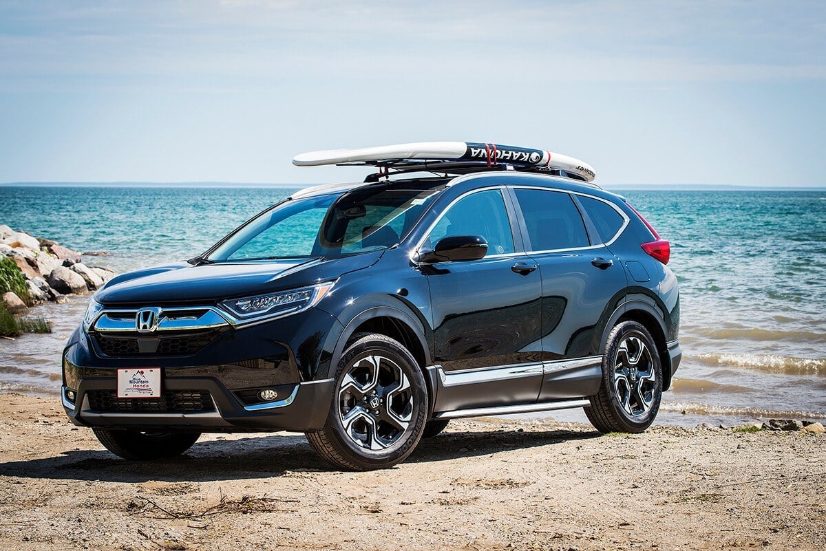   Honda SUV with a surf board