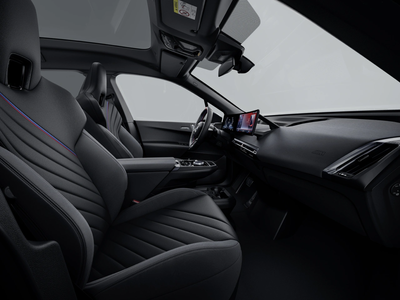 Luxurious interior view of the 2026 BMW iX M70 featuring black sport seats, curved display and panoramic glass sunroof in the background.