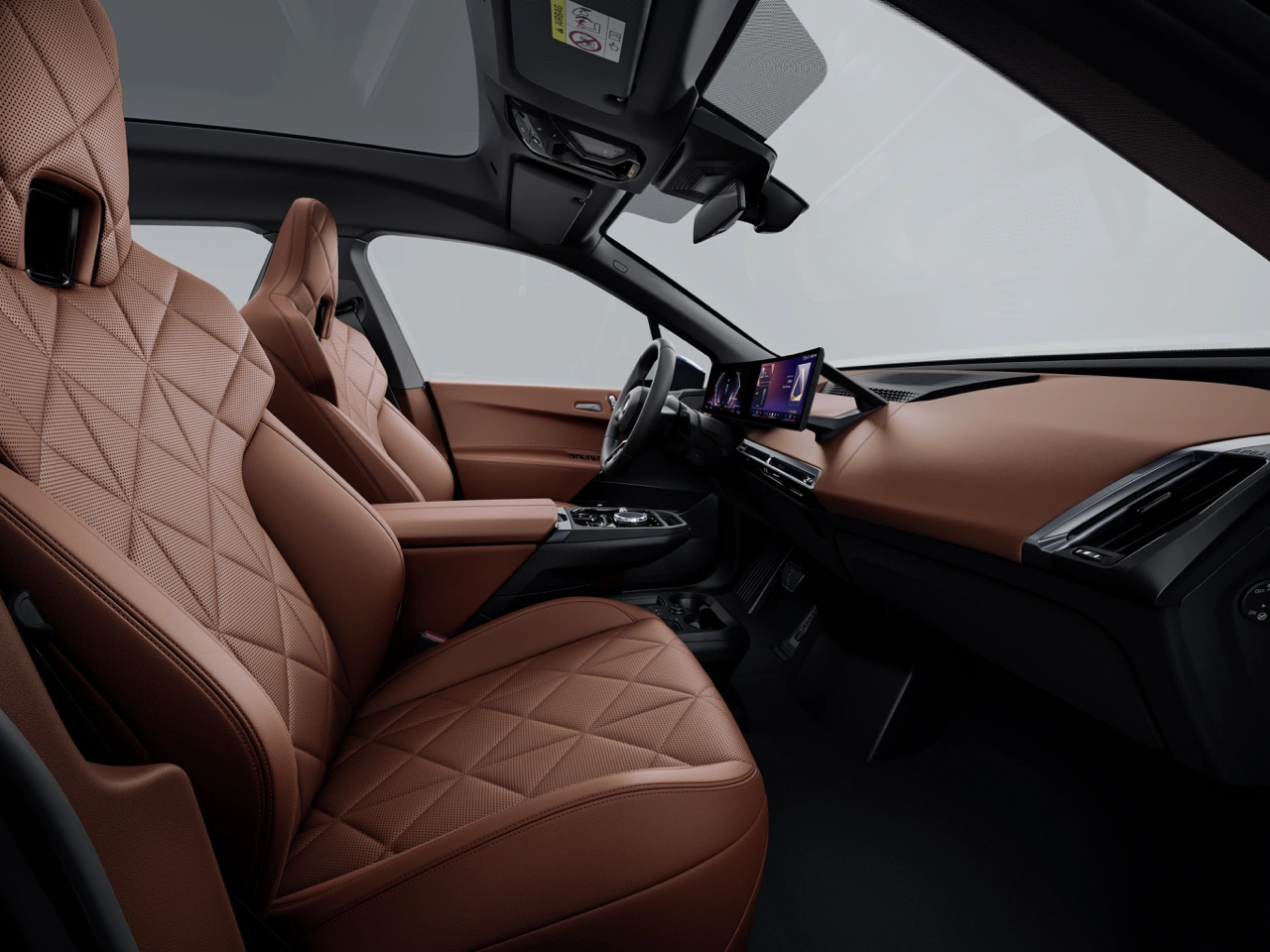 Interior view of the 2026 BMW iX xDrive60 with quilted brown leather seats, minimalist dashboard and driver-oriented curved display.