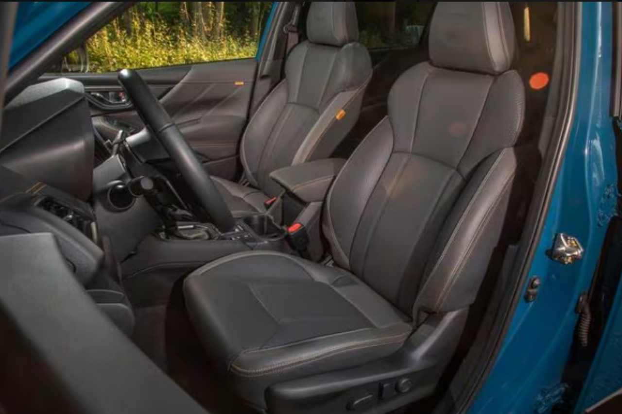 The view from a drivers door-side of the Subaru Forester SUV. Interior of the car showing the steering wheel and front seats.