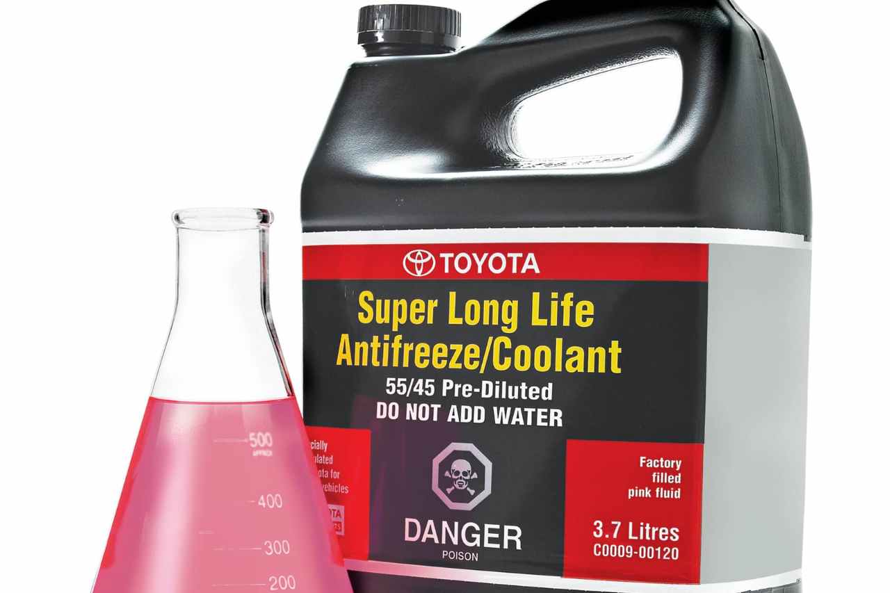 A picture of official Toyota Antifreeze Coolant, next to a beaker filled with pink fluid.