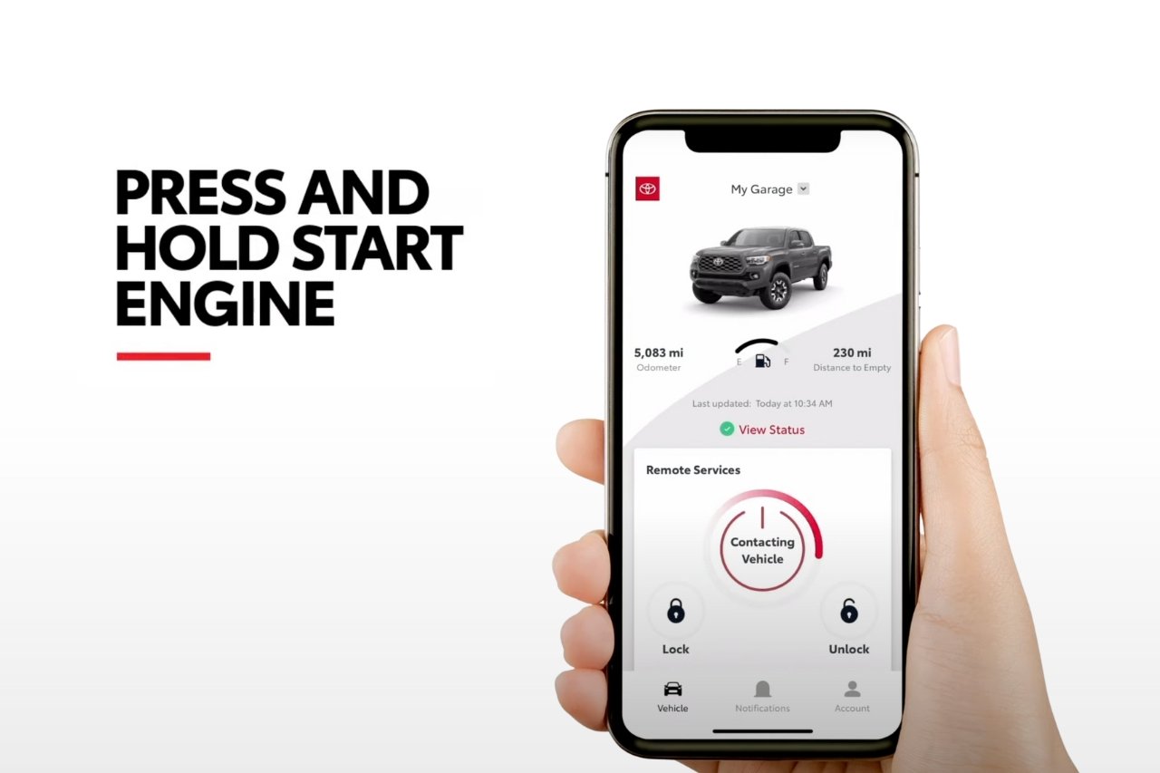 A person holds up their smartphone while they learn how to use the Toyota Remote Connect app.