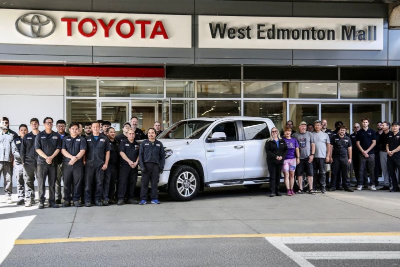 The West Edmonton Mall Toyota team and Jason stand in front of the dealership with his 1 million km Toyota Tundra.