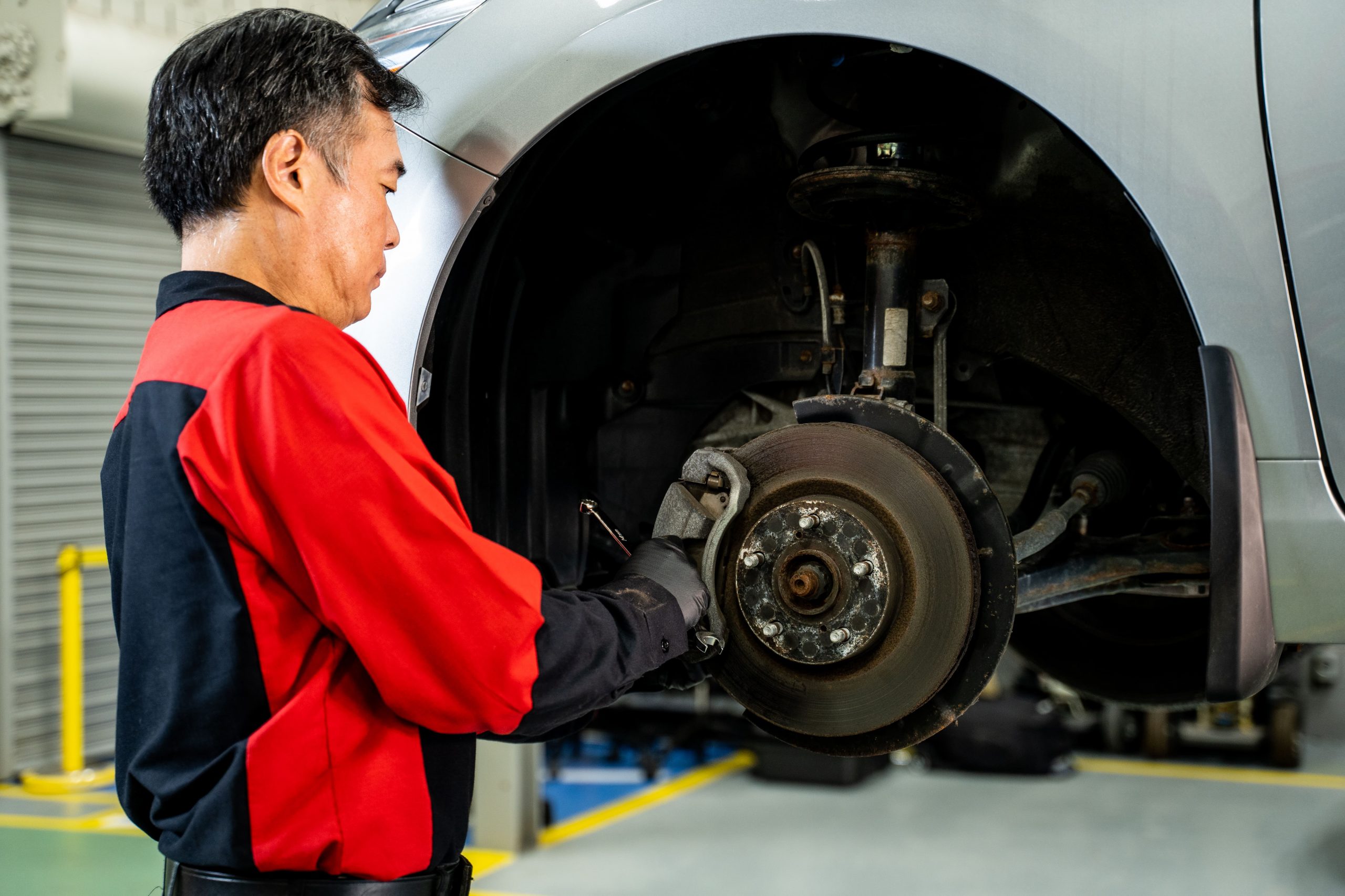 Closeup of a Toyota Technician servicing a Toyota Car