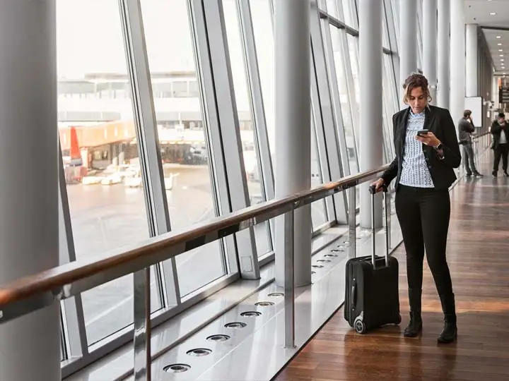 Traveller checking phone in terminal